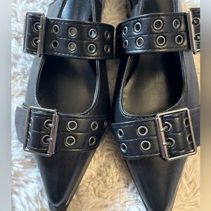 Black multi buckled sling back flats.